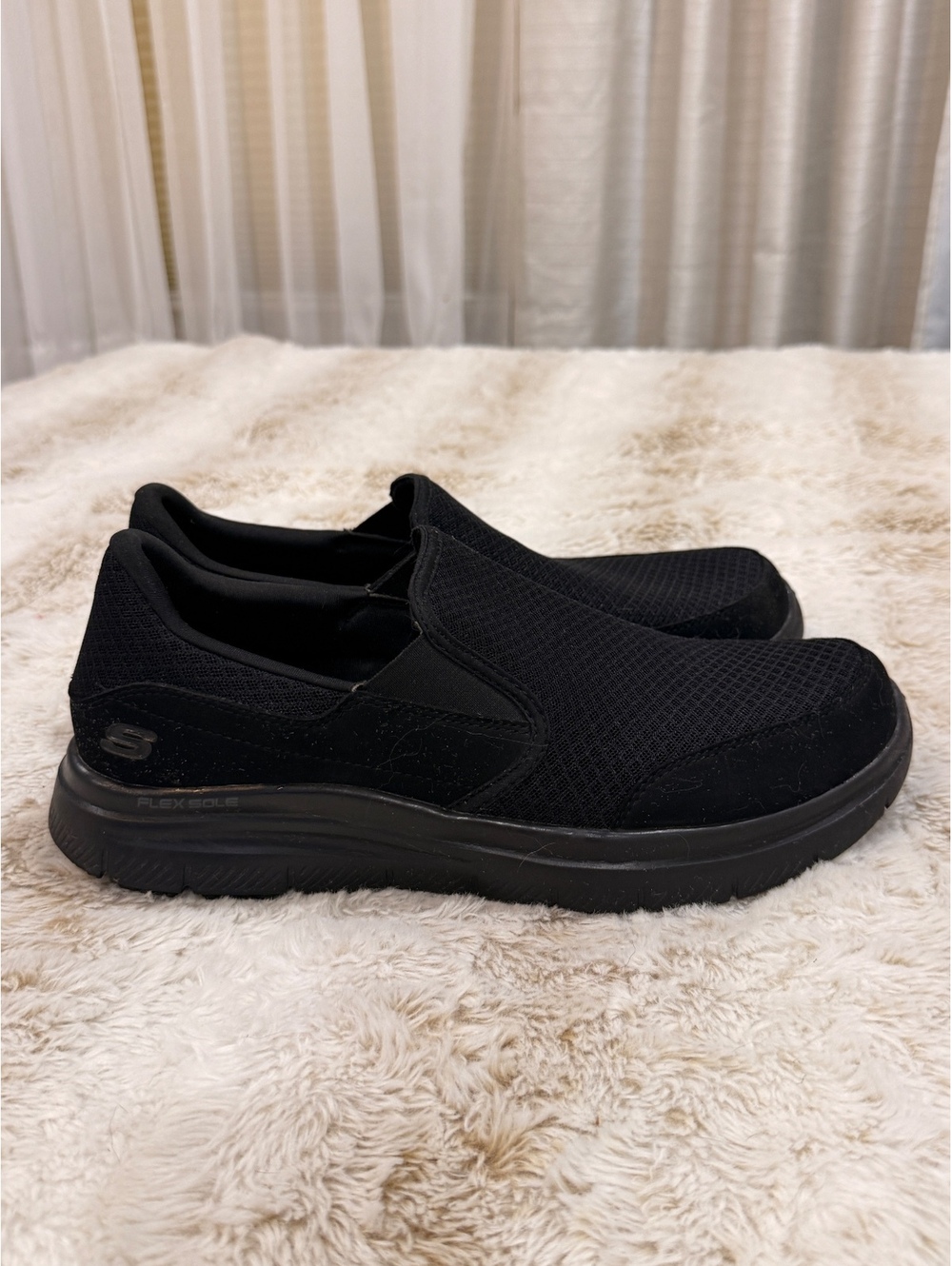 Skechers black slip-on sneakers